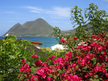 Scenic view of sea and mountains against sky