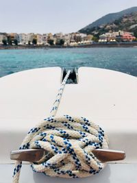 Close-up of rope tied on boat cleat in sea