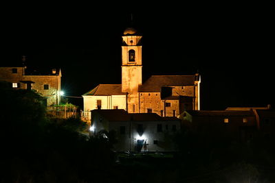 Illuminated building against sky at night