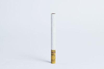 Close-up of cigarette against white background
