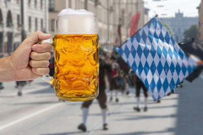 Cropped image of hand holding beer glass