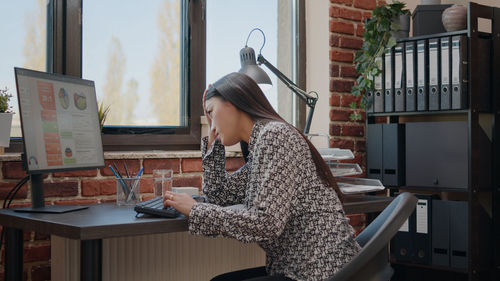Portrait of young woman using phone