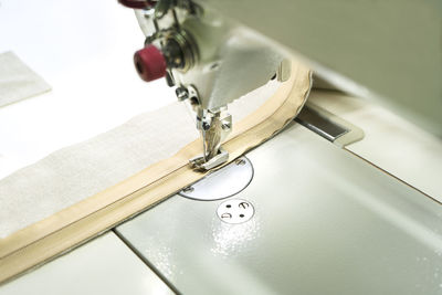 Sewing on industrial sewing machine. stitching a zipper on a sewing machine. sewing process.