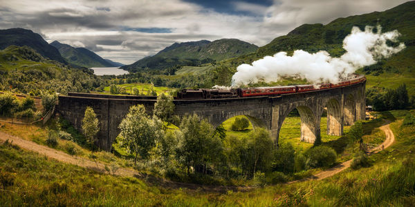 Train on bridge against sky