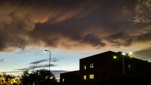 Low angle view of building against cloudy sky