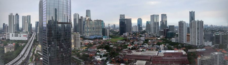 Panoramic view of modern buildings in city against sky