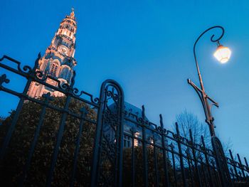 Low angle view of illuminated street light against sky