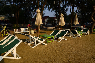 Empty chairs and tables on beach