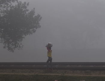 Full length of boy on lake against sky