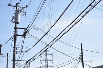 Low angle view of electricity pylon against sky