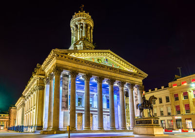 Low angle view of illuminated building at night