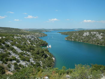 High angle view of trees on shore against sky