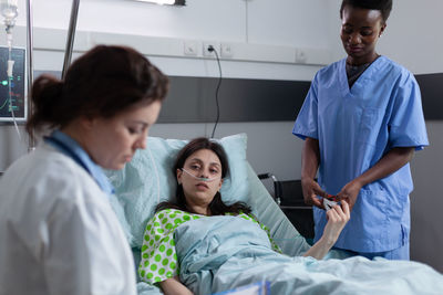 Female doctor examining patient in hospital