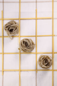 Directly above shot of raw pasta arranged on table