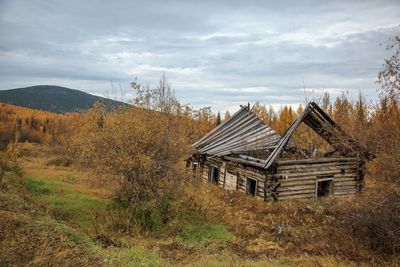 Abandoned built structure on field against sky