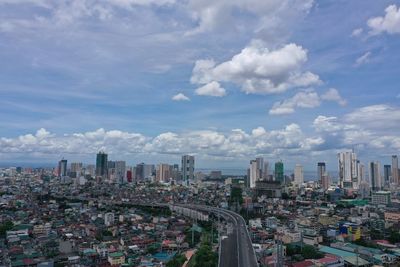 High angle view of modern buildings in city against sky