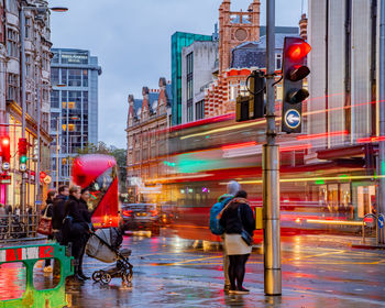 People walking on street in city during rainy season