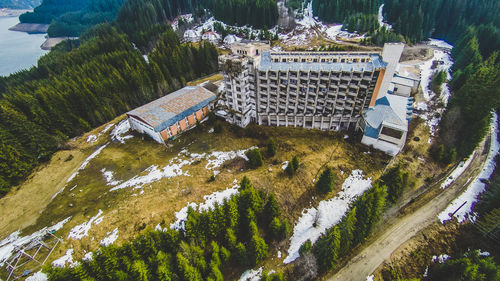 High angle view of building and trees against mountain