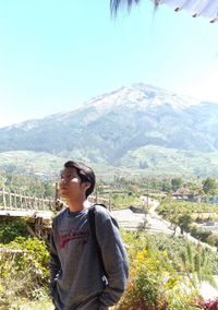 Man standing on mountain against sky