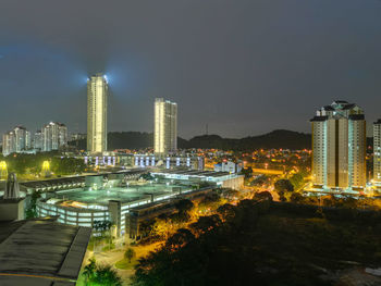 High angle view of illuminated city buildings at night