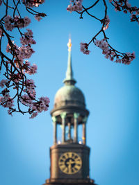 Low angle view of bell tower against blue sky