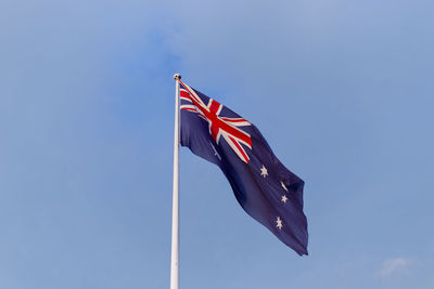 Low angle view of australian flag against blue sky