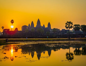 Reflection of temple in water at sunset