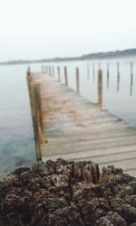 Wooden pier leading towards sea