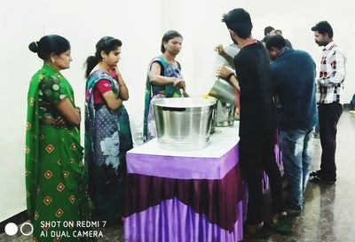 Group of people at market stall