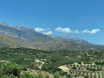 Scenic view of mountains against blue sky