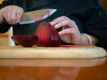 Close-up of person preparing food on cutting board