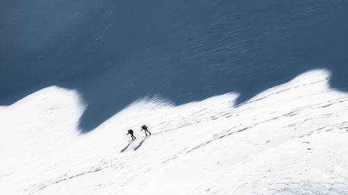 High angle view of people skiing on snowcapped mountain