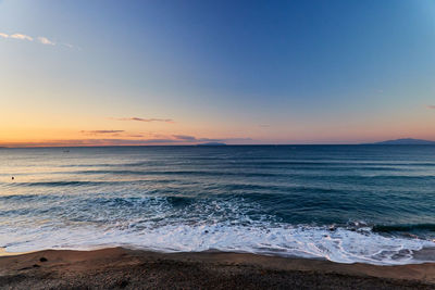 Scenic view of sea against sky during sunrise