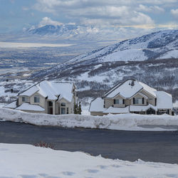 Houses on snow covered mountain