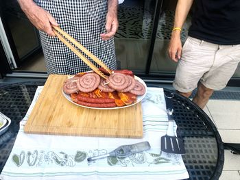 Midsection of man preparing food on table in kitchen