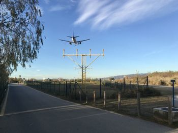 Airplane on road against sky in city