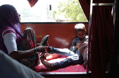 Rear view of people sitting in traditional clothing