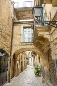 Characteristic street in the historic center of modica with a beautiful stone arch