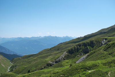 Scenic view of mountains against clear blue sky