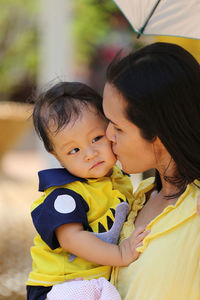 Close-up of mother kissing son