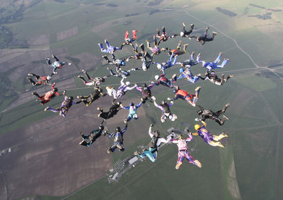 High angle view of people jumping on landscape