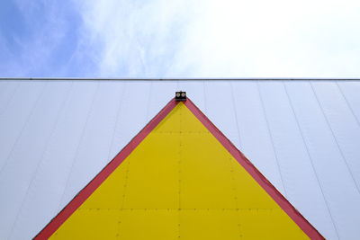 Yellow arrow on white facade