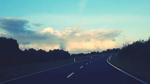 Empty road along countryside landscape