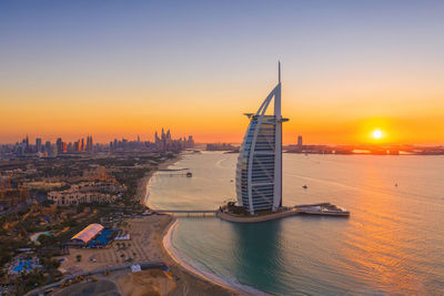 Modern buildings in city during sunset