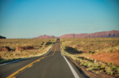 Empty road along countryside landscape