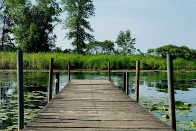 Pier over lake against sky