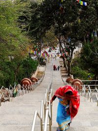 Rear view of people walking on road