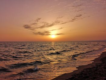 Scenic view of sea against romantic sky at sunset