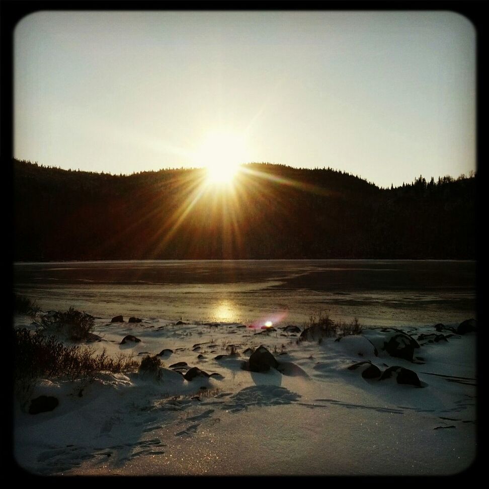 sun, transfer print, tranquil scene, tranquility, auto post production filter, sunlight, nature, scenics, sunset, snow, beauty in nature, clear sky, water, sunbeam, winter, sky, cold temperature, beach, lens flare, landscape