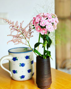 Close-up of pink flower vase on table